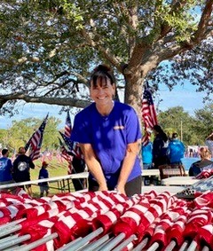 Debbie helping to furl & bundle the flags.