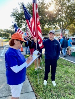 Charlene ensures the flags are being installed in order.