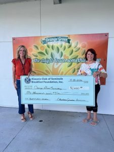 Charlene presents a $1,000 check to Orange Grove Elementary Principal Dr. Christine Wilson.